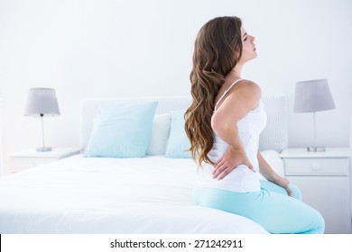 Attractive Woman With Back Pain At Home In The Bedroom