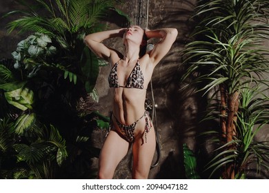 Attractive woman in bikini wash her body in exotic Thailand shower