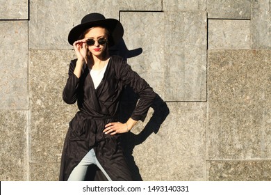 Attractive Woman In Black Trench Suede Coat, Wool Hat And Round Glasses, Artsy Bohemian Style, Fashion Blogger Outfit