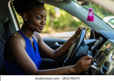 Attractive Woman In Car Driver Seat Adjusting Radio