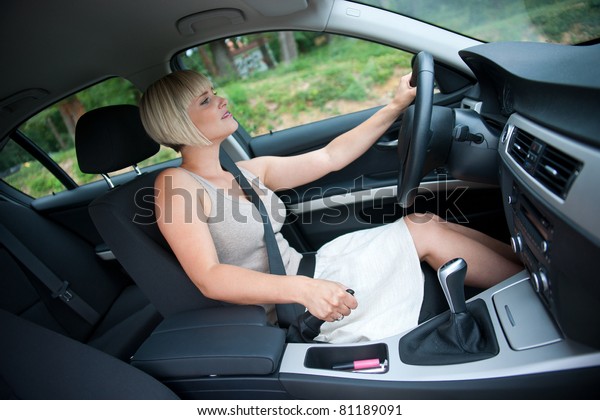 attractive woman in the car using hand brake on the\
steep hill