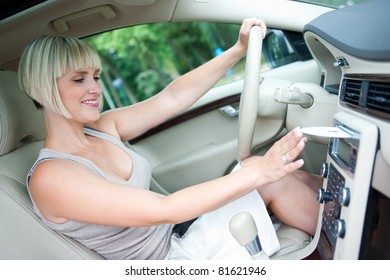 Attractive Woman Changing Cd And Listen Music On Car Radio