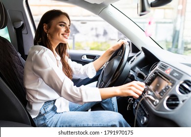 Attractive Woman Changing Radio Station In Her Car