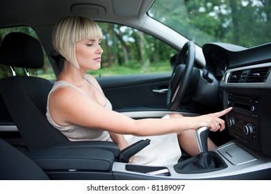 Attractive Woman Changing Radio Station In The Car