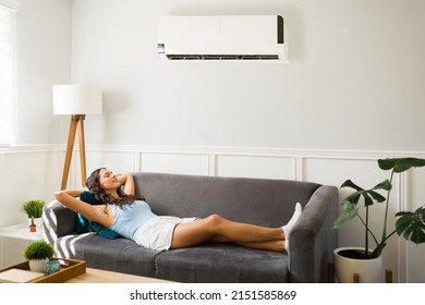 Attractive Woman Chilling And Feeling Very Relaxed On The Sofa While Enjoying Her New Ac Unit During A Hot Summer