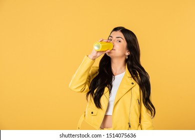 Attractive Woman Drinking Soda From Can, Isolated On Yellow 