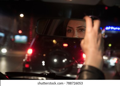 Attractive Woman Driving A Car And Looking At The Rearview Mirror