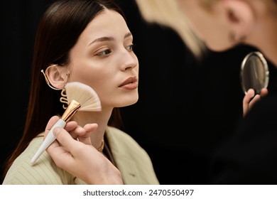 Attractive woman enjoying makeup session with stylist. - Powered by Shutterstock