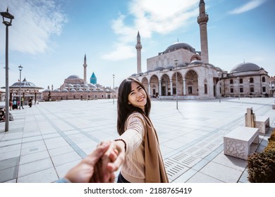 Attractive Woman Holding Hand And Taking Someone To Get Closer With Mosque In The Background