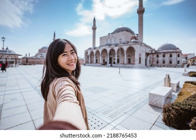 Attractive Woman Holding Hand And Taking Someone To Get Closer With Mosque In The Background