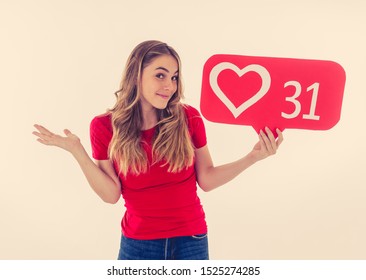 Attractive woman holding heart symbol of like and love social media notification icon happy with followers and fans on the internet. Girl loving having likes In social media obsession and networking. - Shutterstock ID 1525274285
