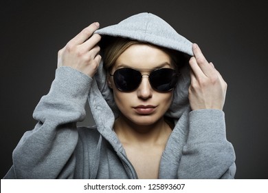 Attractive woman with a hood and sun glasses