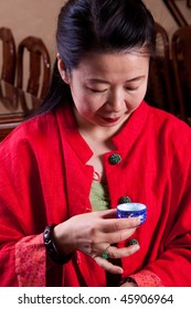 Attractive Woman Inside A Traditional Tea House, Reading Her Tea Leaves