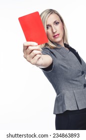 Attractive Woman Issuing A Red Card Holding It Up In Her Hand To Indicate That A Player Is To Be Sent Off The Field, On White