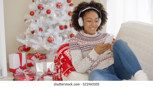 Attractive Woman Listening To Music At Christmas