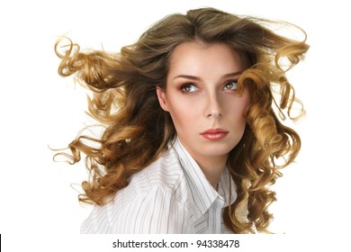 Attractive woman with long curly hair flowing under wind isolated over white background
