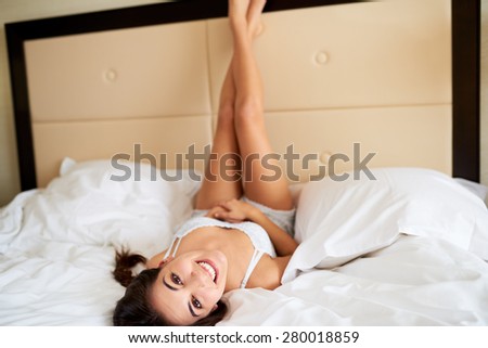 Similar – Image, Stock Photo Young woman lying upside down on an armchair