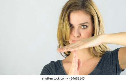attractive woman on plein background shot in studio with soft lights with an interesting expression and dramatic lighting - Powered by Shutterstock
