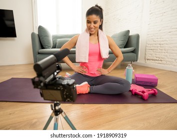 Attractive Woman personal trainer coach recording on camera new content for online fitness business. Freelance filming online training program with virtual workout and exercises for social media.