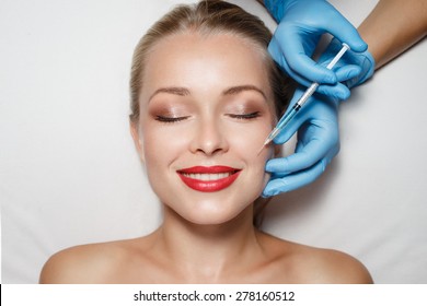 Attractive Woman At Plastic Surgery With Syringe In Her Face