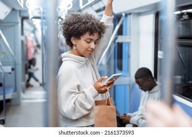 Attractive Woman Reading Electronic Correspondence In A Subway Car .