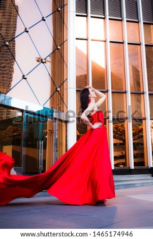 Attractive woman in red fluttered dress. Fire, flame, passion concept. Red Moscow