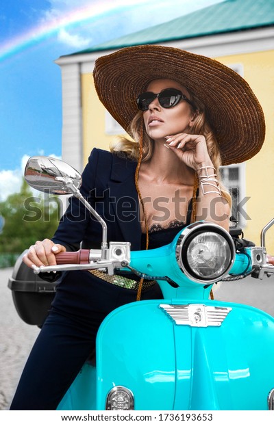 Attractive woman riding on motorbike in street,\
summer vacation style, traveling, smiling, happy, having fun,\
stylish outfit, adventures. Spring fashion model. Girl on a pink\
scooter - Image