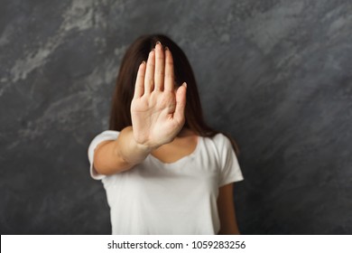 Attractive woman saying thanks but no. Beautiful girl denying proposal, making stop gesture, covering face with her hand, copy space - Shutterstock ID 1059283256