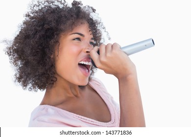 Attractive Woman Singing In Microphone Against White Background