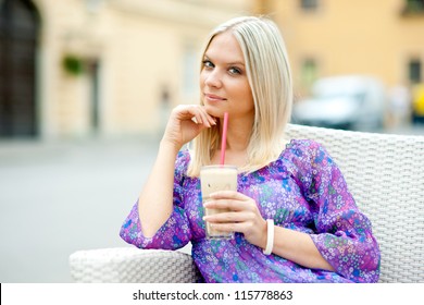 Attractive Woman Sitting In Outdoor Cafe And Drinking Ice Coffee