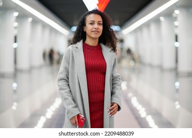 Attractive Woman With A Smartphone Walking Down The Steps In The Subway.