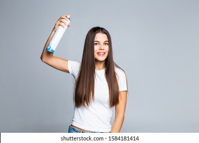 Attractive Woman Spraying Hairspray Isolated On A White Background