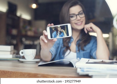 Attractive woman taking self portrait by mobile phone  - Powered by Shutterstock