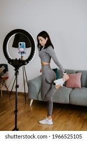 Attractive Woman Virtual Fitness Workout At Home. Fitness Influencer. Fitness Workout Exercises Online Women At Home. Fitness Influencer Personal Trainer Coach Recording On Smartphone Camera New