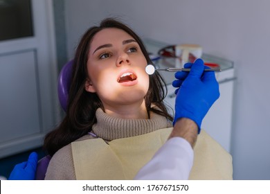 Attractive Woman Visiting Dentist, Doctor Doing Dental Examination Before Treatment. Dentist Office. 