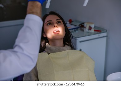 Attractive Woman Visiting Dentist, Doctor Doing Dental Examination Before Treatment. Dentist Office. 