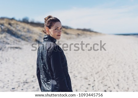 Similar – Woman walking on a beach on a cloudy day