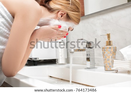 attractive woman to wash in bathroom after applying mask