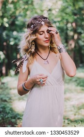 Attractive Woman In White Bohemian Dress.
Woman Hands With Lot Of Boho Style Jewelry, Blue Rings,silver Bracelets And Henna Tattoo.  Coachella Fashion Style Look, Outfit