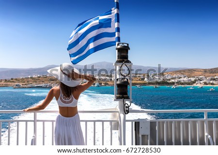Attractive woman in a white dress on a Greek ferry boat traveling through the cyclades of Greece