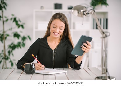 Attractive woman working in modern office - Shutterstock ID 526410535