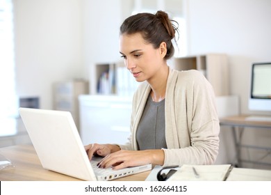 Attractive Woman Working In Office On Laptop