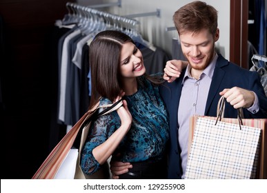 Attractive Woman And Young Man Go Shopping At The Store