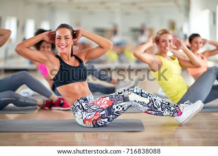 Attractive women train in group on fitness class