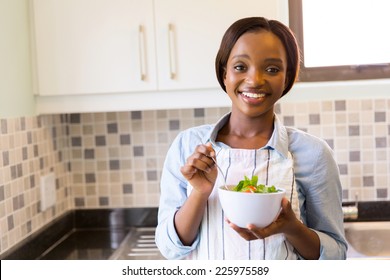 Attractive Young African Woman Having Green Salad In Kitchen