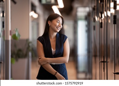 Attractive Young Asian Ethnicity Businesswoman Standing In Modern Office Hallway, Career Growth Of Successful Employee, Corporation Owner Planning Future Goals Feels Satisfied, Business Vision Concept