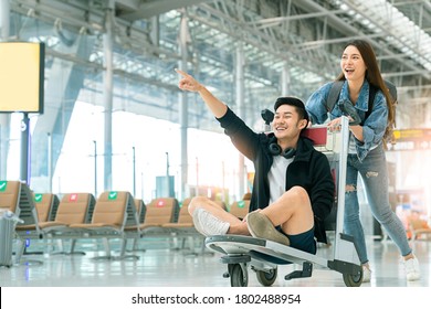 Attractive Young Asian Tourist Couple Excited Together For The Trip Boyfriend Sitting And Cheering On Baggage Trolley Or Luggage Trolley Holiday Vacation Safety Traveling Abroad Ideas Concept