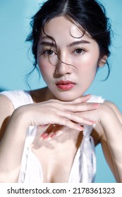 Attractive Young Asian Wet Hair Woman Model With Perfect  Fresh Skin On Underwater Simulation Of Lighting. Face Care, Facial Treatment, Cosmetology, Plastic Surgery, Lovely Girl Portrait In Studio.