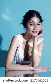Attractive young Asian wet hair woman model with perfect  fresh skin on underwater simulation of lighting. Face care, Facial treatment, Cosmetology, Plastic Surgery, Lovely girl portrait in studio.