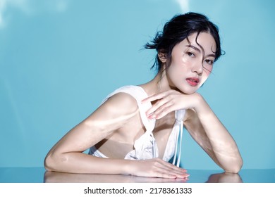 Attractive Young Asian Wet Hair Woman Model With Perfect  Fresh Skin On Underwater Simulation Of Lighting. Face Care, Facial Treatment, Cosmetology, Plastic Surgery, Lovely Girl Portrait In Studio.